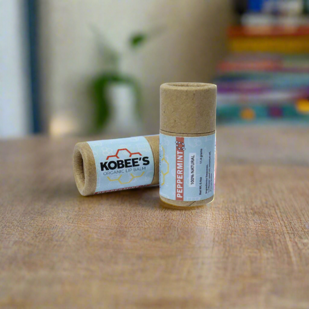 Kobbee's Peppermint lip balm laying down and standing up